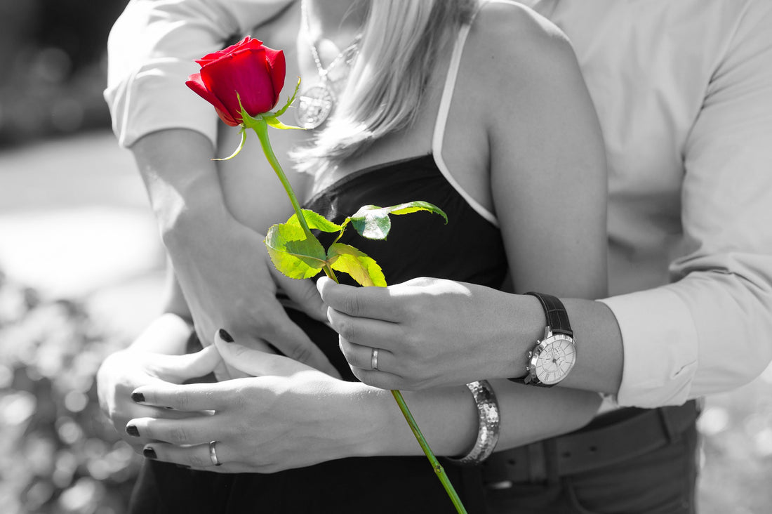 A couple in love as the man passes his partner a red rose - and so the love is shown - Tim Downer Celebrant