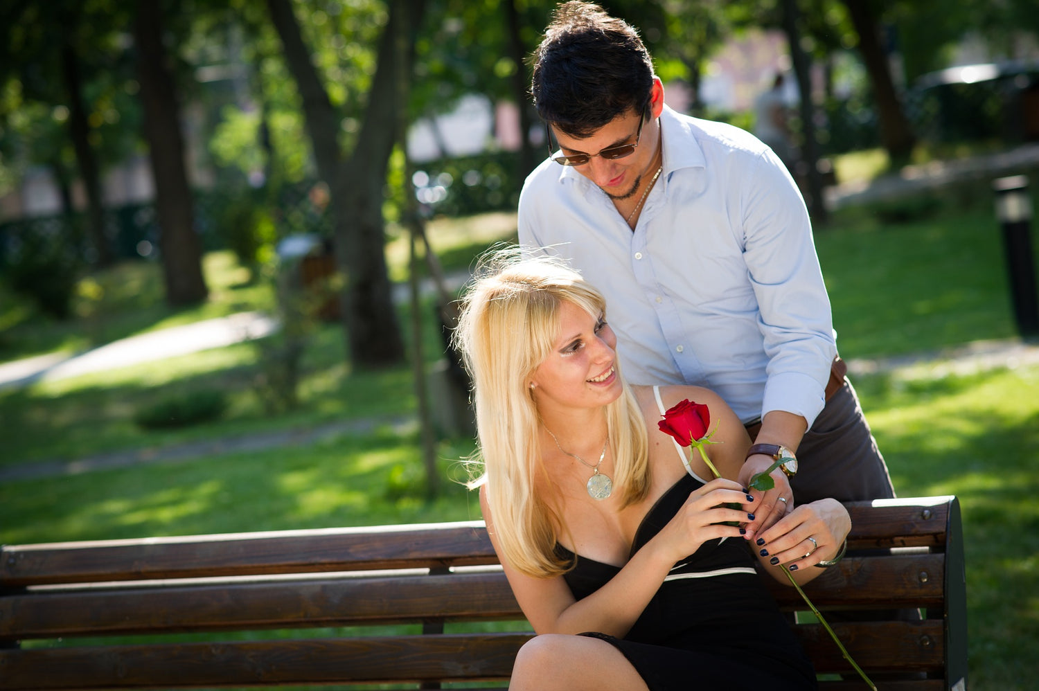 Image of a male giving his partner a red rose to show how much he loves her - Tim Downer Celebrant